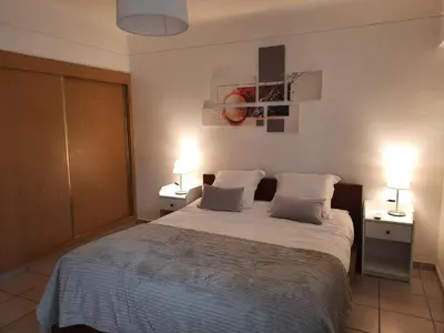 a bedroom with a large bed with two night stands at Appartement Algarve,Quarteira Vilamoura Lago Azul in Vilamoura