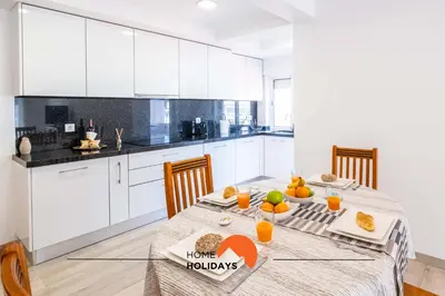a kitchen with a table with fruit on it at #089 Largo Escola by Home Holidays in Albufeira