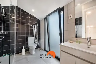 a bathroom with a toilet and a sink and a mirror at #211 Cerro Lagoa by Home Holidays in Albufeira
