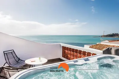 a hot tub on a balcony overlooking the ocean at #211 Cerro Lagoa by Home Holidays in Albufeira