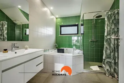a bathroom with a sink and a shower with green tiles at #211 Cerro Lagoa by Home Holidays in Albufeira