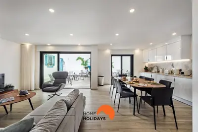 a kitchen and living room with a table and chairs at #211 Cerro Lagoa by Home Holidays in Albufeira