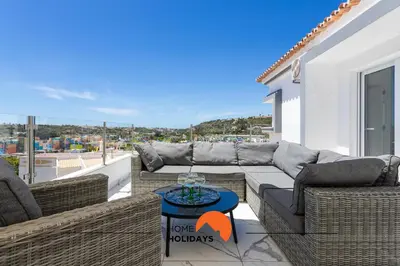 a patio with couches and a table on a balcony at #221 Cerro Grande by Home Holidays in Albufeira