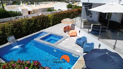 an overhead view of a swimming pool with an umbrella and chairs at #221 Cerro Grande by Home Holidays in Albufeira