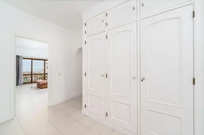 a white closet with white cabinets in a room at 404 - Oura - 2 Bedroom - Sea View in Albufeira