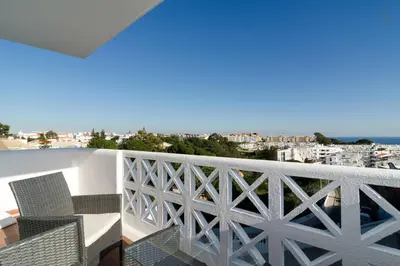 a balcony with chairs and a view of the city at 404 - Oura - 2 Bedroom - Sea View in Albufeira