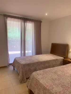 a hotel room with two beds and a window at Villa Sofia in Almancil
