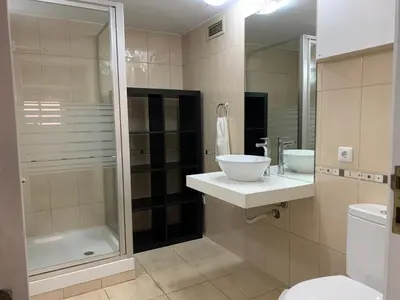 a bathroom with a sink and a shower and a toilet at Villa Sofia in Almancil