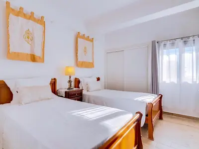 a bedroom with two beds and a window at Noah House, 2 bdr apartment with sea view in Quarteira