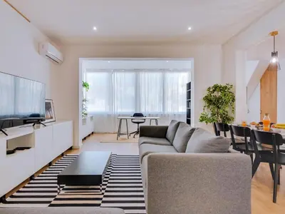 a living room with a couch and a table at Apartment with Rooftop and work space in Quarteira in Quarteira