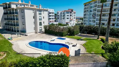 a swimming pool in front of some buildings at #230 Only Families - Flat A Flor by Home Holidays in Albufeira