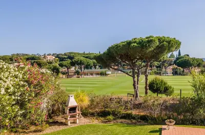 a view of a golf course from a garden at Villa Vilamoura NATURE GREEN GOLF AND POOL in Quarteira