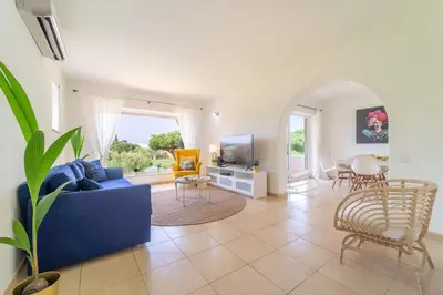 a living room with a blue couch and chairs at Villa Vilamoura NATURE GREEN GOLF AND POOL in Quarteira