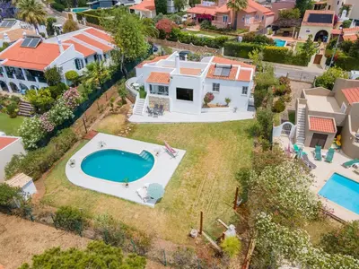 an aerial view of a house with a swimming pool at Villa Vilamoura NATURE GREEN GOLF AND POOL in Quarteira