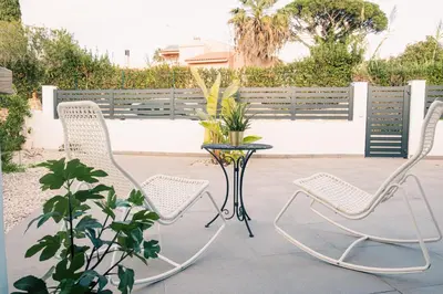 two chairs and a table on a patio at Studio LUMINEUX et CALME à Vilamoura in Quarteira