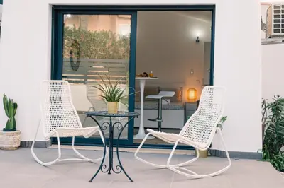 two chairs and a table on a patio at Studio LUMINEUX et CALME à Vilamoura in Quarteira