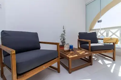two chairs and a coffee table in a room at Brisa Mar-Aveiros Apatment by Dalma Portuguesa in Albufeira