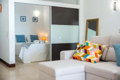 a living room with a couch and a bed at Brisa Mar-Aveiros Apatment by Dalma Portuguesa in Albufeira