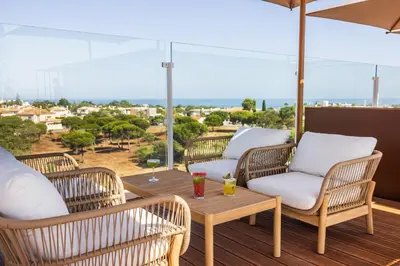 a large glass building with a lot of windows at Castelo Suites Hotel in Albufeira