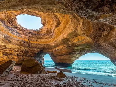 a large rock formation on a beach with the ocean at Aqua Plaza 2 Bedr swimming pool 5 min to the beach in Olhos de Água