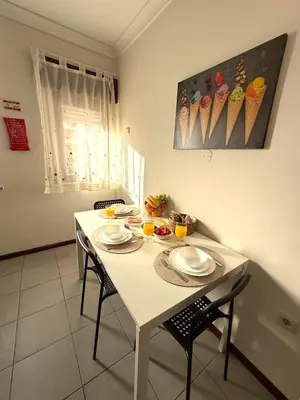 a white table with chairs and plates and drinks on it at Aqua Plaza 2 Bedr swimming pool 5 min to the beach in Olhos de Água