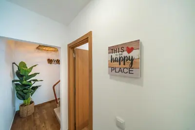 a sign that reads this is a happy place on a wall at Oldtown Starfish Beach House 2 min to the beach Wifi in Albufeira