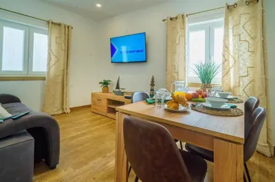 a living room with a wooden table with fruit on it at Oldtown Starfish Beach House 2 min to the beach Wifi in Albufeira