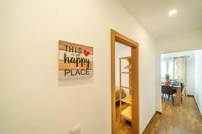 a room with a mirror and a sign on a wall at Oldtown Starfish Beach House 2 min to the beach Wifi in Albufeira