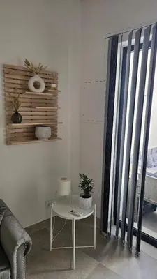 a living room with a table and a window at City Center Villa in Faro