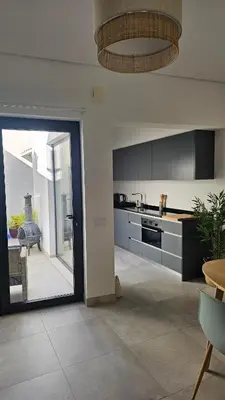 a kitchen with a large glass door leading to a patio at City Center Villa in Faro