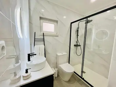 a bathroom with a shower and a toilet and a sink at BrisaMarVilas Sea view, 5 min Walk to Town & Beach in Albufeira