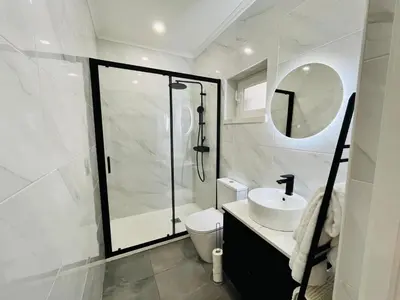a bathroom with a shower and a toilet and a sink at BrisaMarVilas Sea view, 5 min Walk to Town & Beach in Albufeira