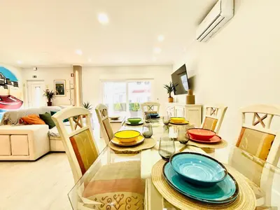 a dining room with a glass table and chairs at BrisaMarVilas Sea view, 5 min Walk to Town & Beach in Albufeira