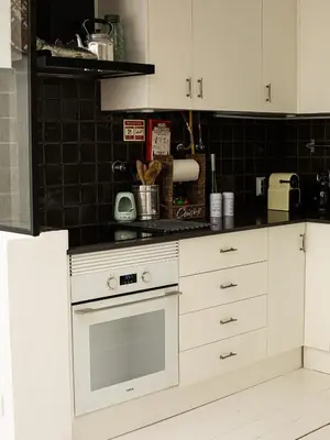 a kitchen with white cabinets and a stove top oven at Vilamouratenis White by SAPvillas in Vilamoura