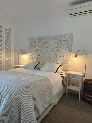 a bedroom with a large bed with a large headboard at Vilamouratenis White by SAPvillas in Vilamoura
