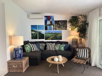 a living room with a couch and a table at Vilamouratenis White by SAPvillas in Vilamoura