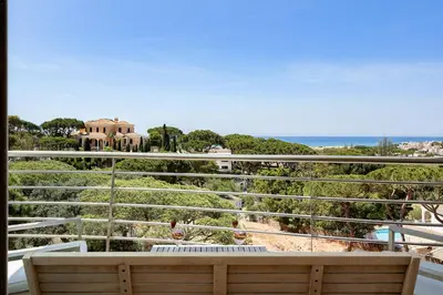 a balcony with a bench and a view of the ocean at Apartment Atlantic - Vale de Lobo in Almancil