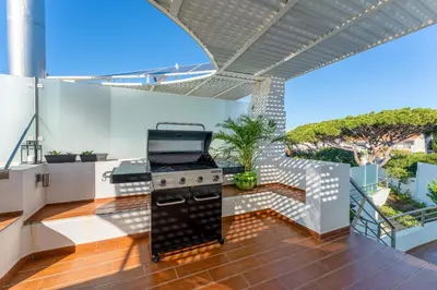 an outdoor kitchen with a grill in a house at Apartment Atlantic - Vale de Lobo in Almancil