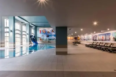 a large building with a pool and chairs in it at Self-Catering Studios & Apartments at Hotel Cerro Alagoa in Albufeira