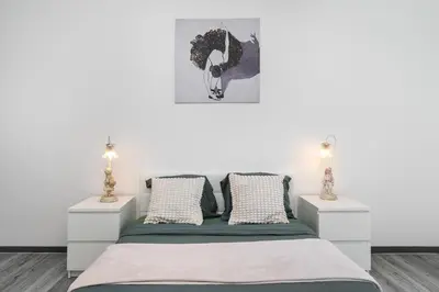a bedroom with a bed with two night stands at Vilamoura Family Escape in Quarteira