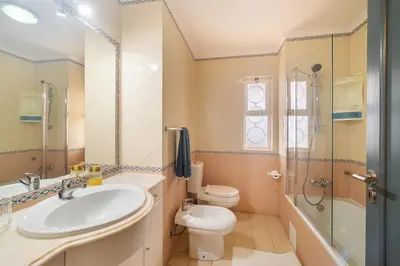 a bathroom with a sink and a toilet and a shower at Vilamoura Family Escape in Quarteira