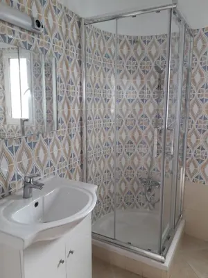 a bathroom with a shower and a sink at Quarteira Azul in Quarteira
