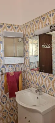 a bathroom with a sink and a mirror at Quarteira Azul in Quarteira