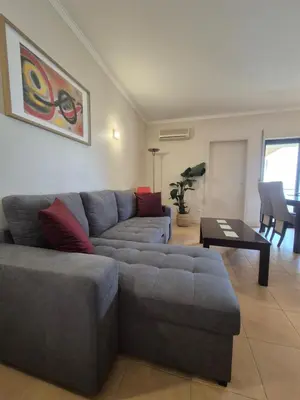 a living room with a couch and a table at Casa Algarve in Albufeira