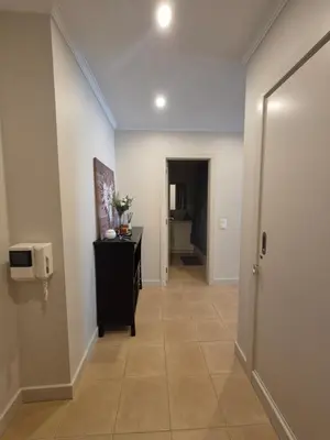 a hallway with a tv and a tiled floor at Casa Algarve in Albufeira