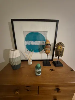 a wooden dresser with a picture and other items on it at Casa Algarve in Albufeira