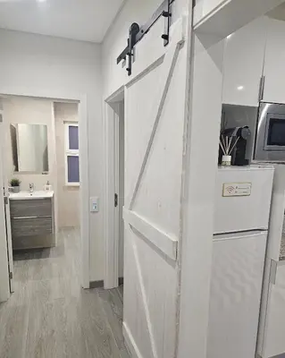 a sliding barn door in a kitchen with a sink at Oldtown Nightlife in Faro