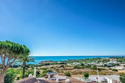 a view of a beach with palm trees and the ocean at Atlantic Sul in Albufeira