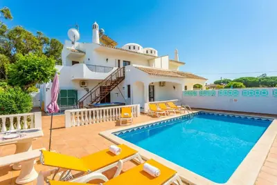 a villa with a swimming pool and a house at Villa Praia in Albufeira