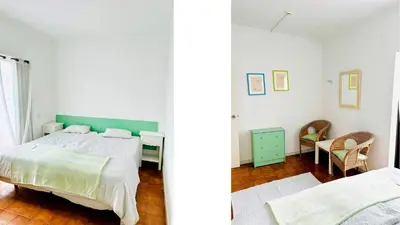 a white bedroom with a bed and a desk at Rich & Poor Hostel Albufeira in Albufeira